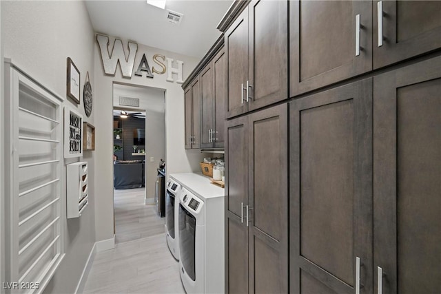 laundry room featuring cabinets and washing machine and clothes dryer