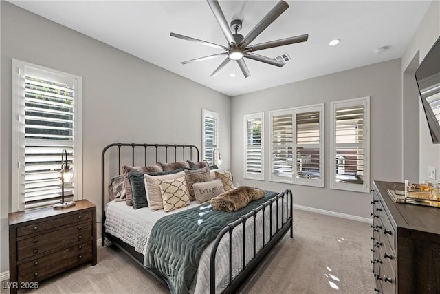 bedroom featuring ceiling fan and light carpet