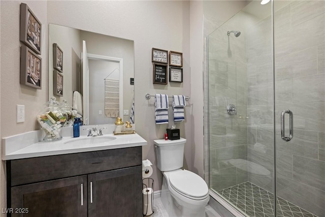 bathroom featuring vanity, an enclosed shower, and toilet