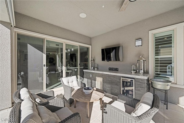 view of patio with wine cooler, ceiling fan, and an outdoor living space