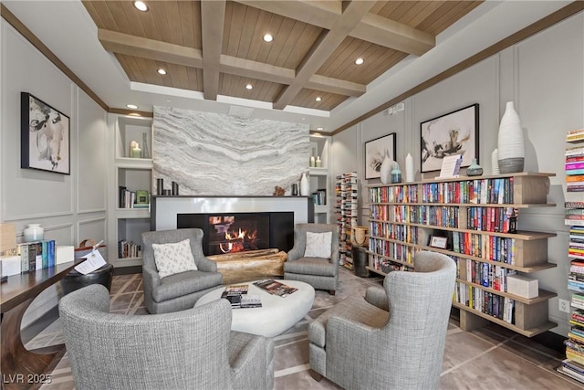 living area featuring beamed ceiling, built in features, wood ceiling, and coffered ceiling