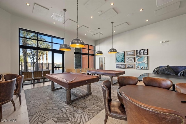 game room with light tile patterned floors, a towering ceiling, and billiards