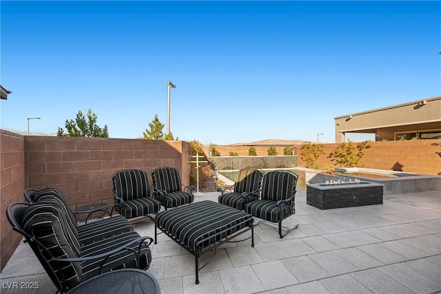 view of patio / terrace with a fire pit