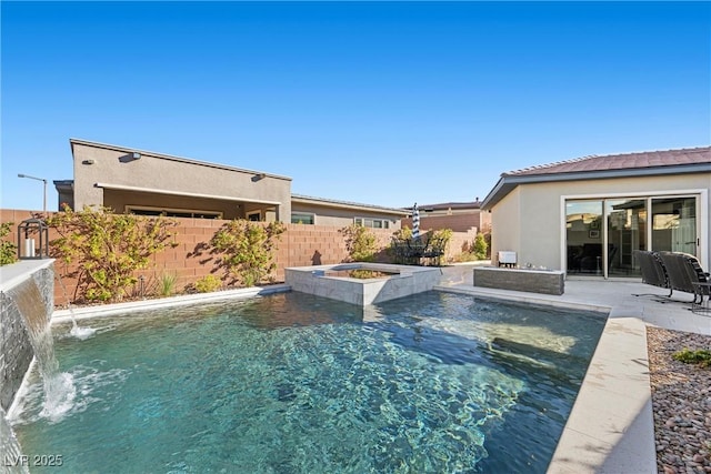 view of pool featuring an in ground hot tub, pool water feature, and a patio