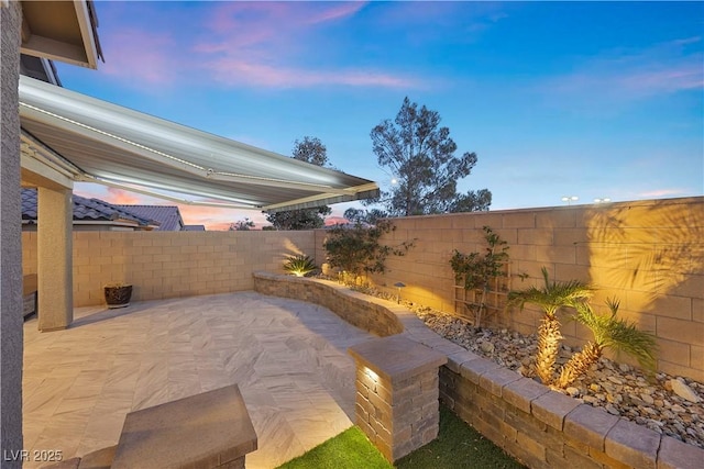 view of patio terrace at dusk