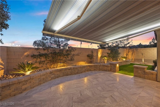 view of patio terrace at dusk