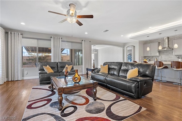 living room with ceiling fan and hardwood / wood-style flooring