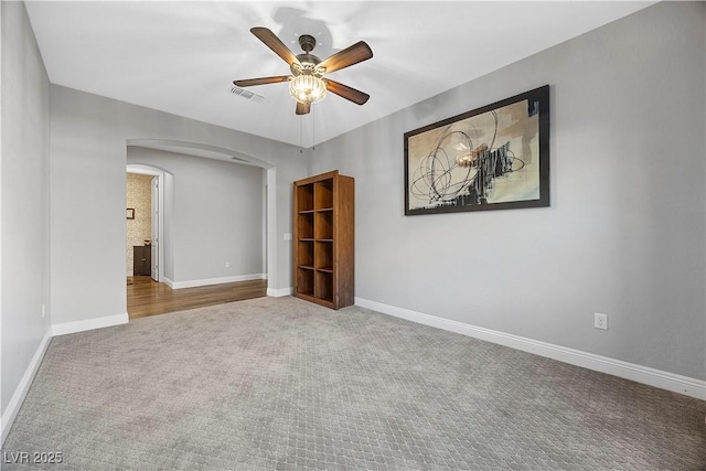 empty room featuring carpet flooring and ceiling fan