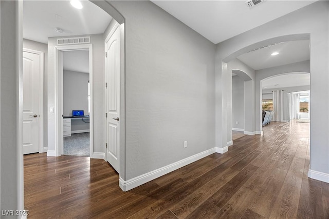 hallway with dark wood-type flooring