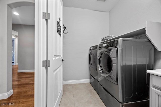 laundry room with light tile patterned floors and separate washer and dryer