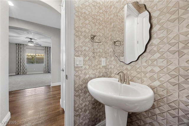 bathroom with hardwood / wood-style floors, ceiling fan, and sink