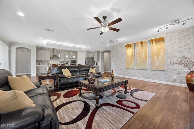 living room featuring hardwood / wood-style flooring and ceiling fan