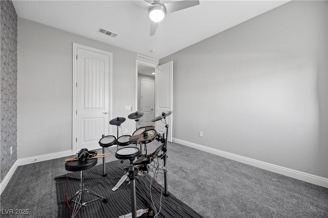 interior space featuring dark colored carpet and ceiling fan