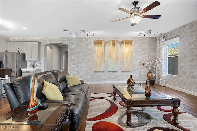 living room featuring ceiling fan and wood-type flooring