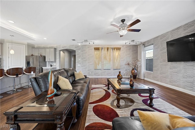 living room featuring ceiling fan and hardwood / wood-style floors