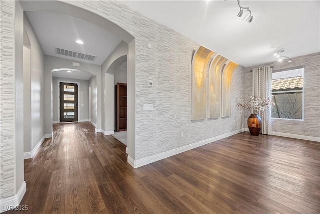 foyer entrance featuring dark wood-type flooring