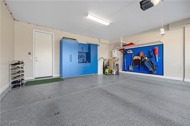 garage featuring a garage door opener and water heater