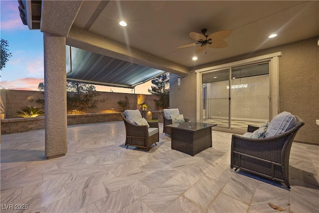 patio terrace at dusk featuring outdoor lounge area and ceiling fan