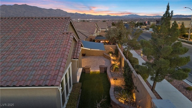 aerial view at dusk featuring a mountain view