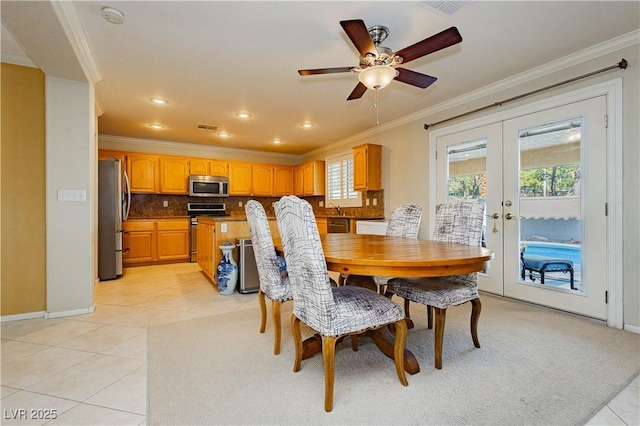 dining space featuring french doors, ceiling fan, ornamental molding, and light tile patterned flooring