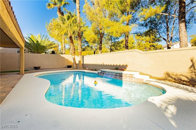 view of swimming pool with pool water feature, a patio, and a hot tub