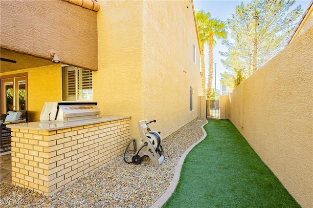 view of side of property featuring an outdoor kitchen