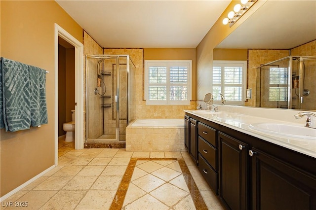 full bathroom featuring vanity, shower with separate bathtub, and toilet