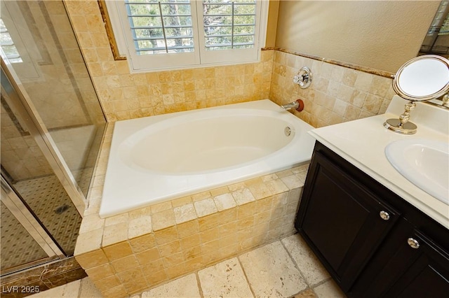 bathroom with vanity and independent shower and bath