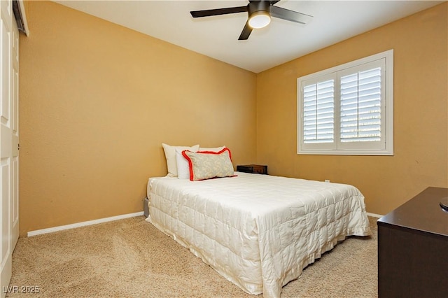 bedroom with light carpet and ceiling fan