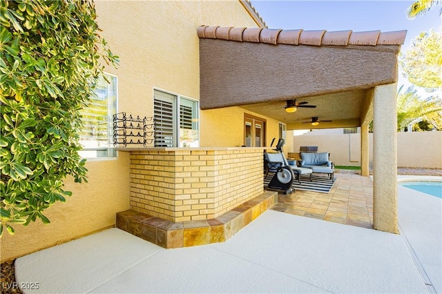 view of patio with ceiling fan and an outdoor hangout area