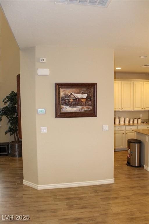 hallway with light hardwood / wood-style flooring