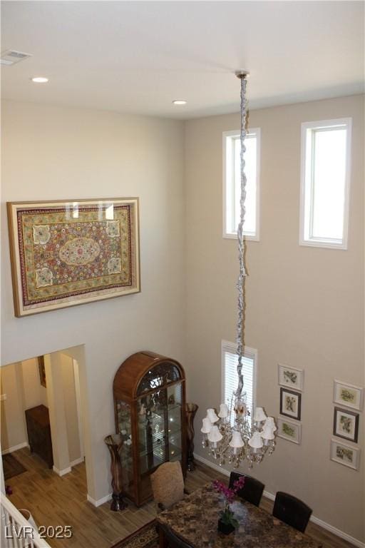 interior space with hardwood / wood-style floors and a notable chandelier