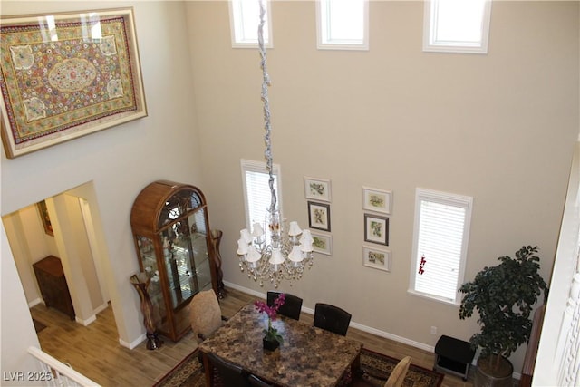 interior space featuring hardwood / wood-style flooring and an inviting chandelier