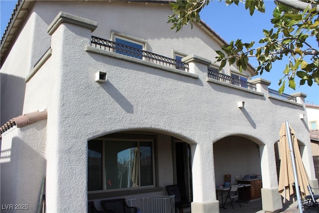 view of property exterior featuring a patio area