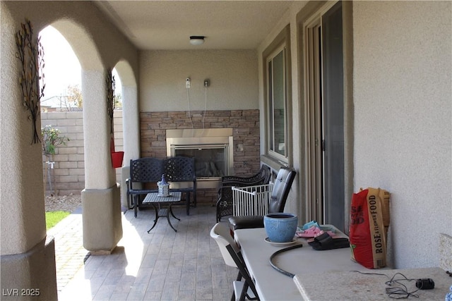 view of patio with an outdoor stone fireplace