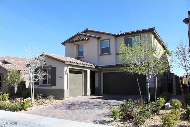 mediterranean / spanish-style home with a garage