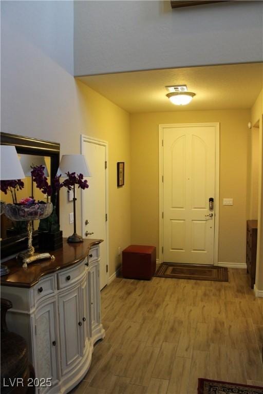 foyer entrance with hardwood / wood-style floors