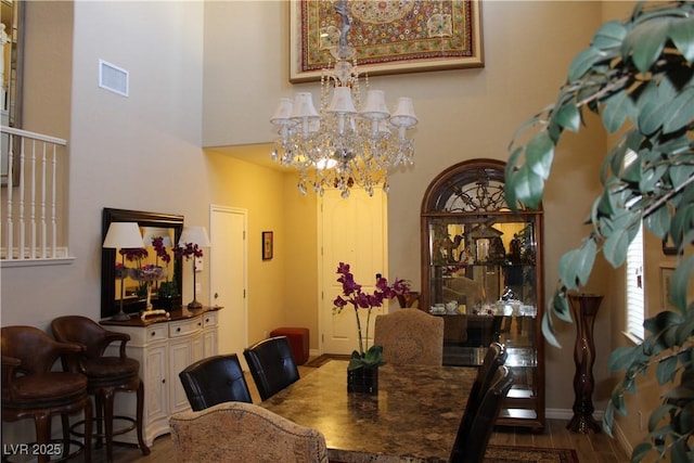 dining space featuring a chandelier and hardwood / wood-style flooring