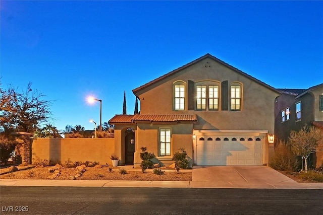 mediterranean / spanish home with a garage