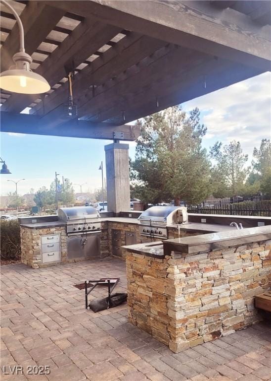 view of patio / terrace featuring a pergola and area for grilling