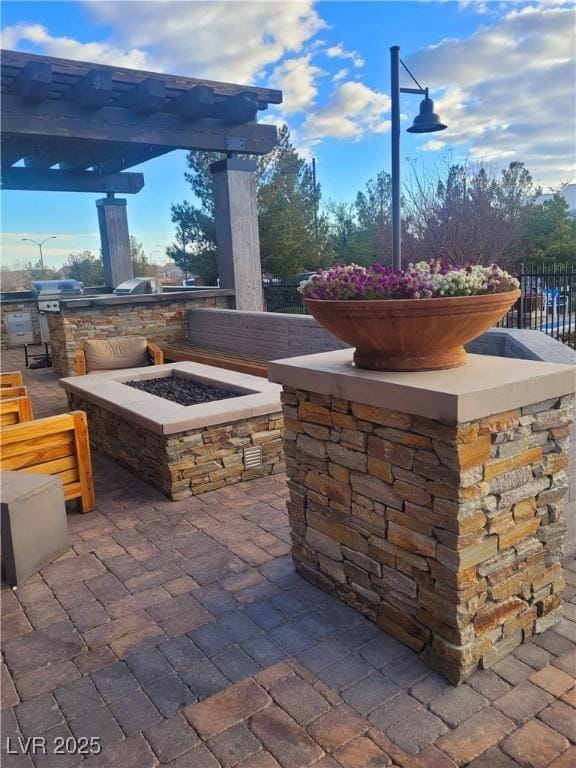 view of patio featuring area for grilling and a fire pit