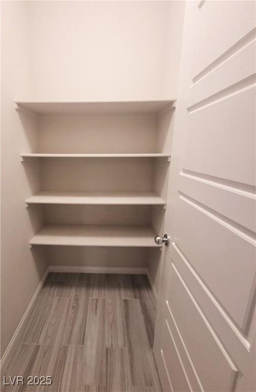 spacious closet featuring hardwood / wood-style floors