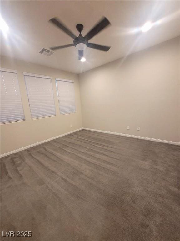 carpeted spare room with ceiling fan