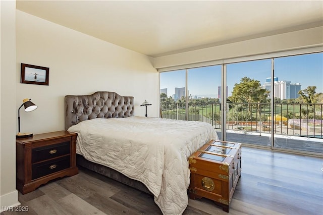 bedroom featuring dark hardwood / wood-style flooring and access to outside