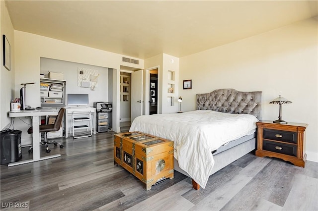 bedroom with dark wood-type flooring