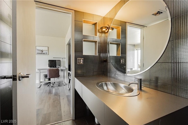 bathroom with hardwood / wood-style floors and vanity