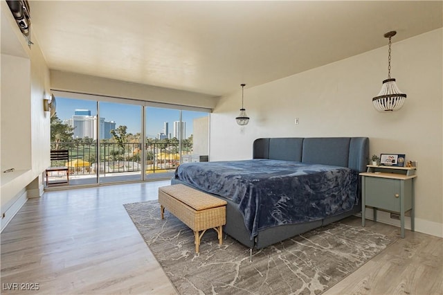 bedroom featuring access to outside and hardwood / wood-style flooring