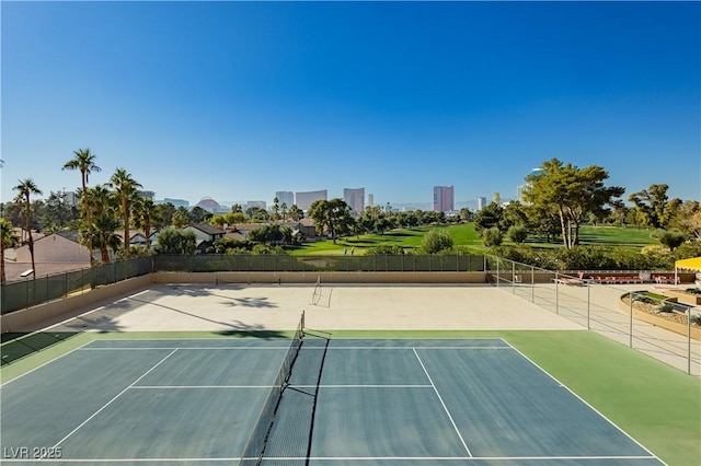 view of tennis court with basketball hoop