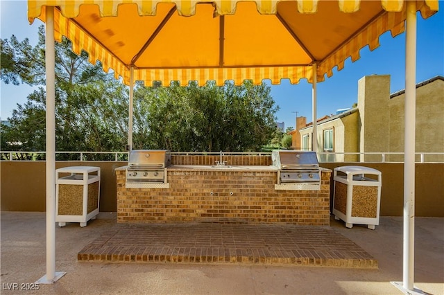 view of patio / terrace featuring area for grilling, sink, and an outdoor kitchen