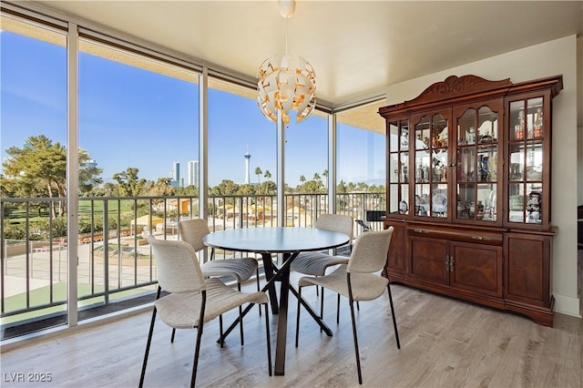 sunroom / solarium featuring a notable chandelier